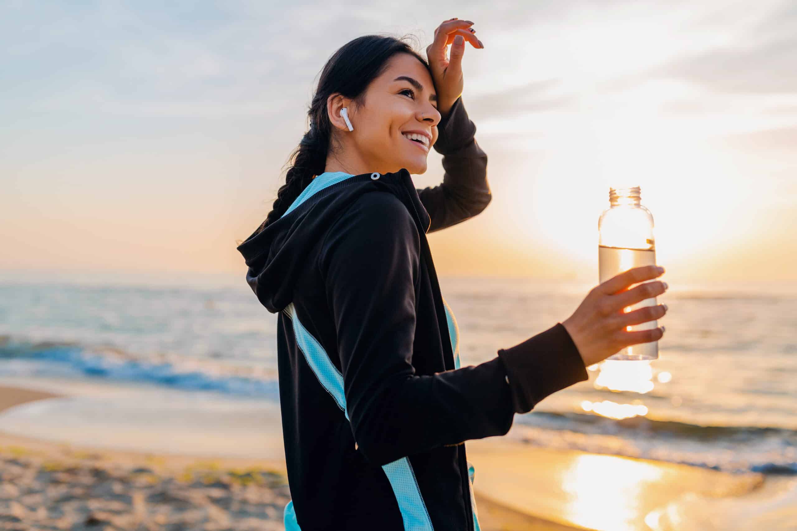 https://www.theinspirationedit.com/wp-content/uploads/2022/10/attractive-slim-woman-doing-sport-exercises-morning-sunrise-beach-sports-wear-thirsty-drinking-water-bottle-healthy-lifestyle-listening-music-wireless-earphones-feeling-hot-scaled.jpg